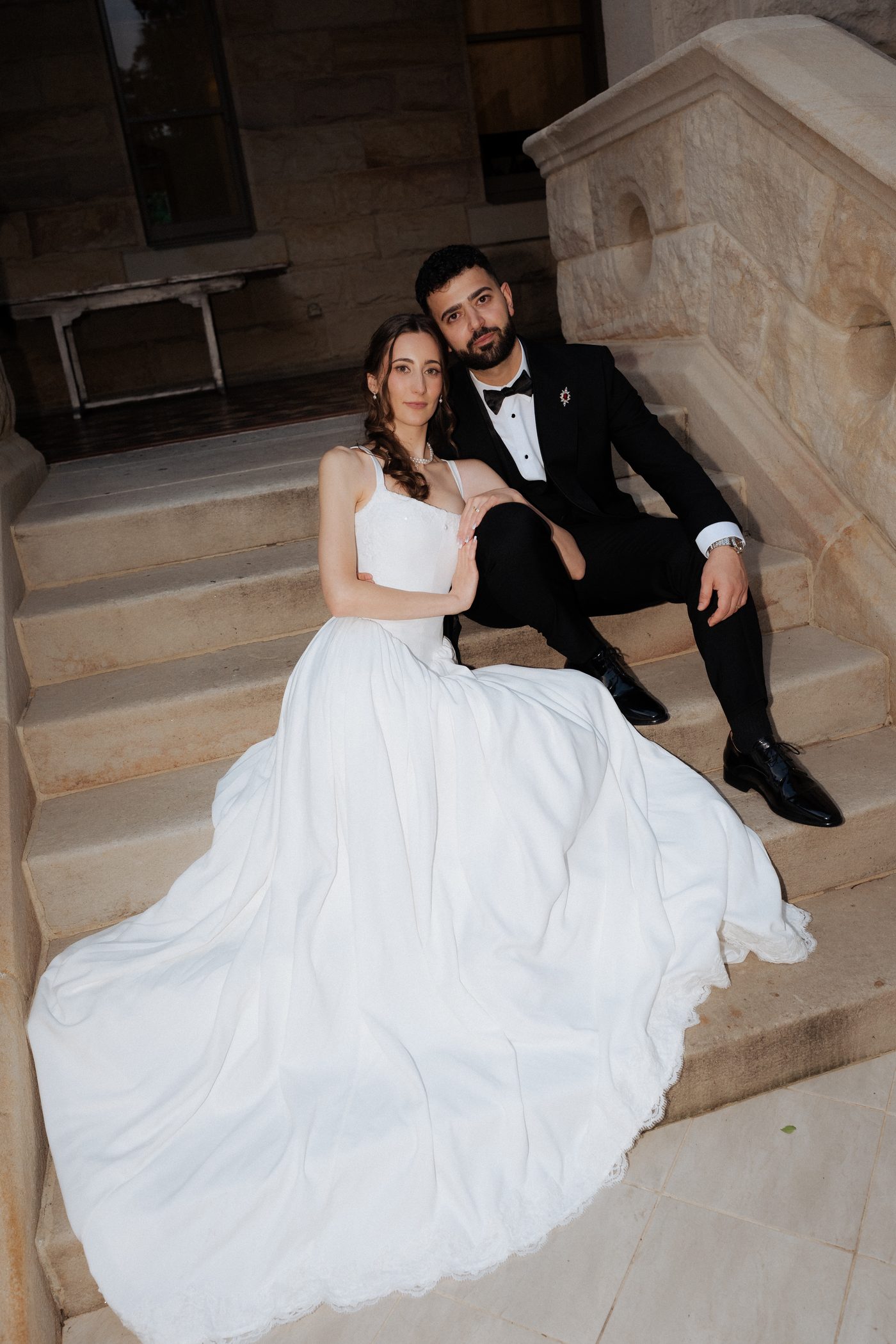Ashleigh and Morry together on the sandstone steps of the State Library of NSW wedding portrait