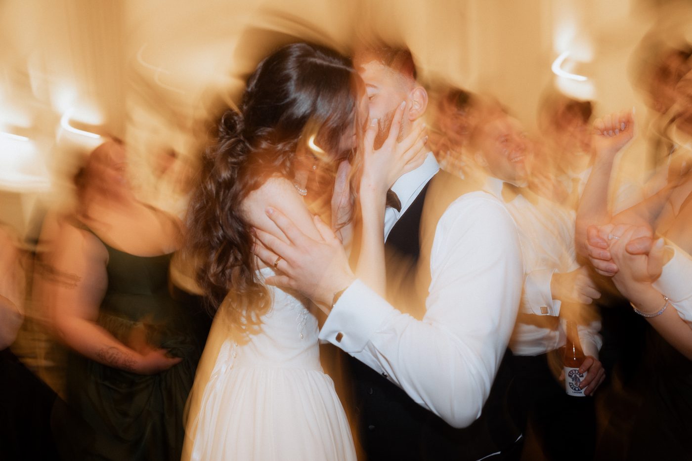 Bride and groom kissing on the dance floor at Curzon Hall wedding reception captured with motion blur