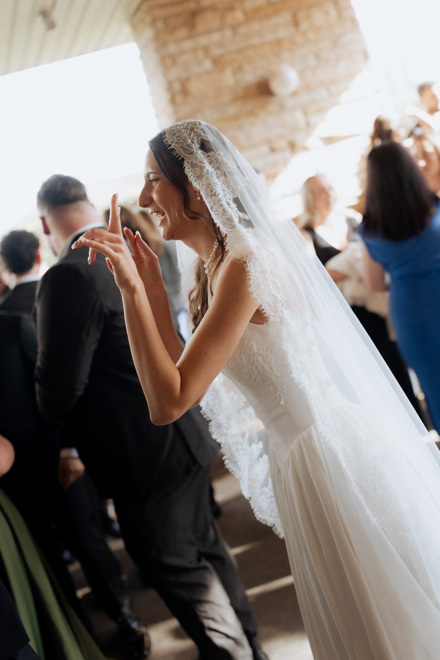 Bride Ashleigh laughing and showing off her wedding ring after the ceremony