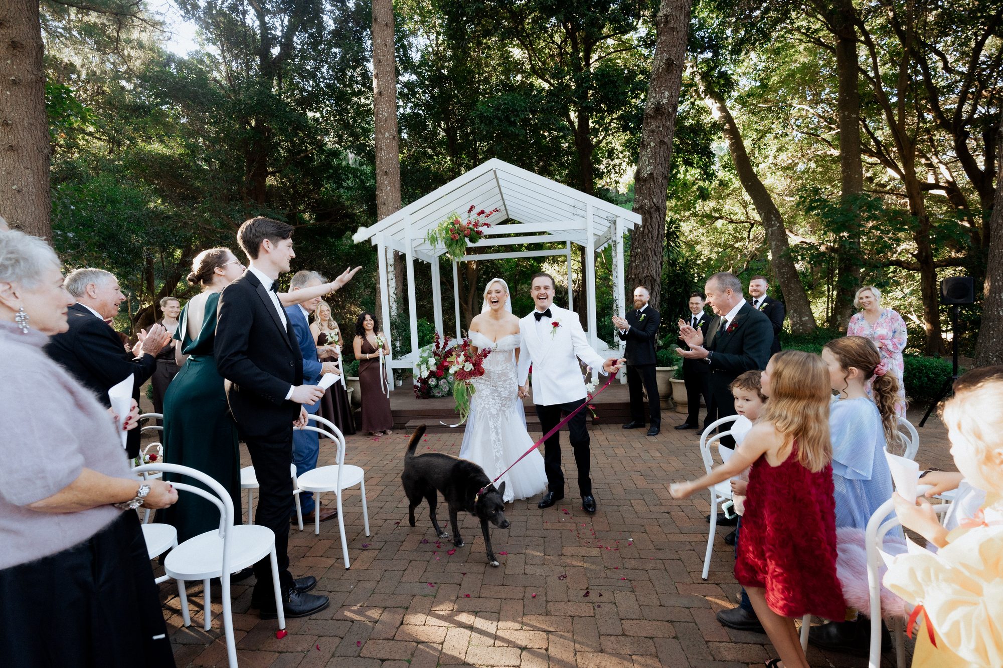 Elena and Bill walking out with their dog at the recessional — The Lodge Jemberoo wedding