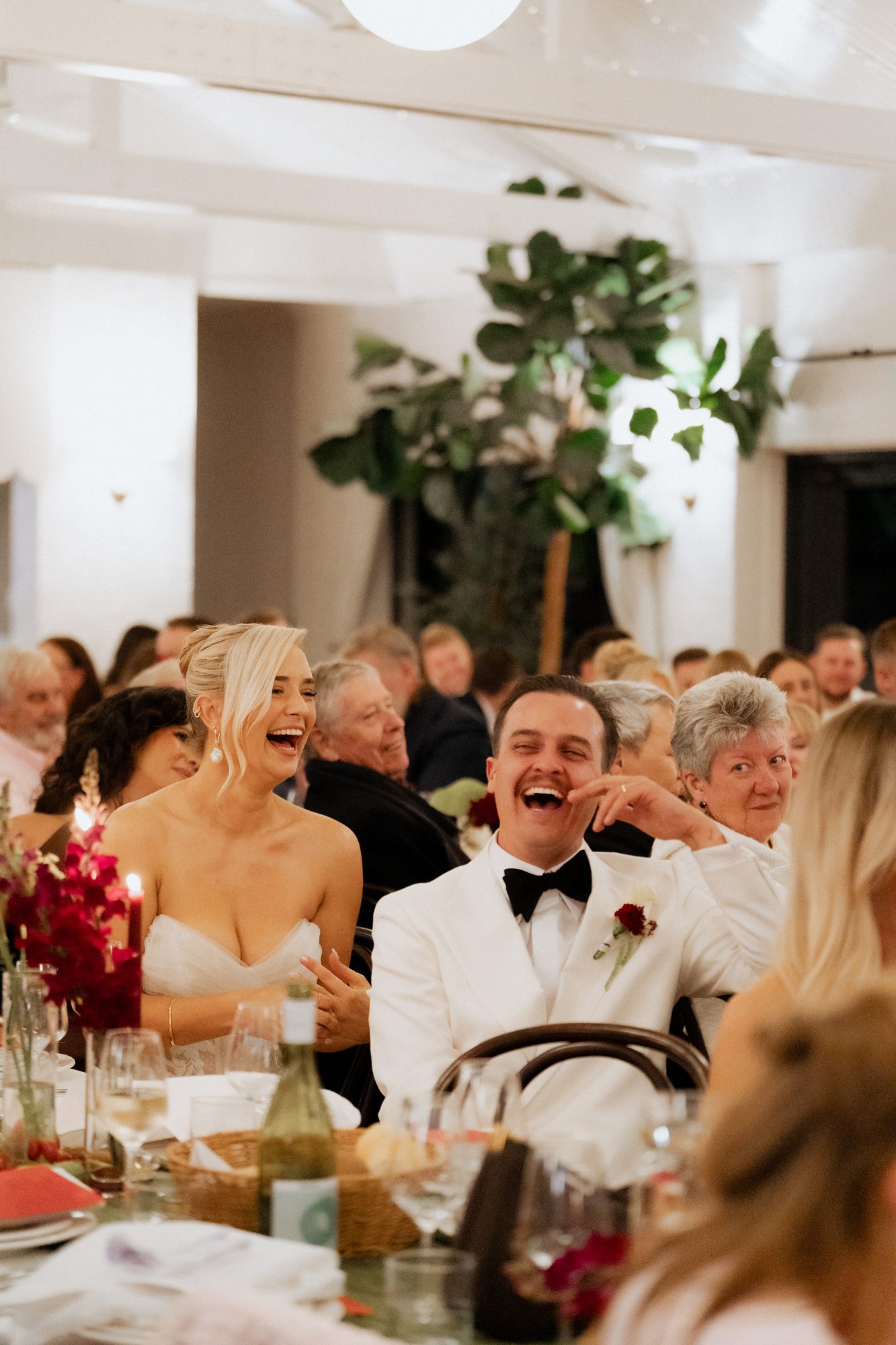 Elena and Bill laughing during wedding speeches — The Lodge Jemberoo reception