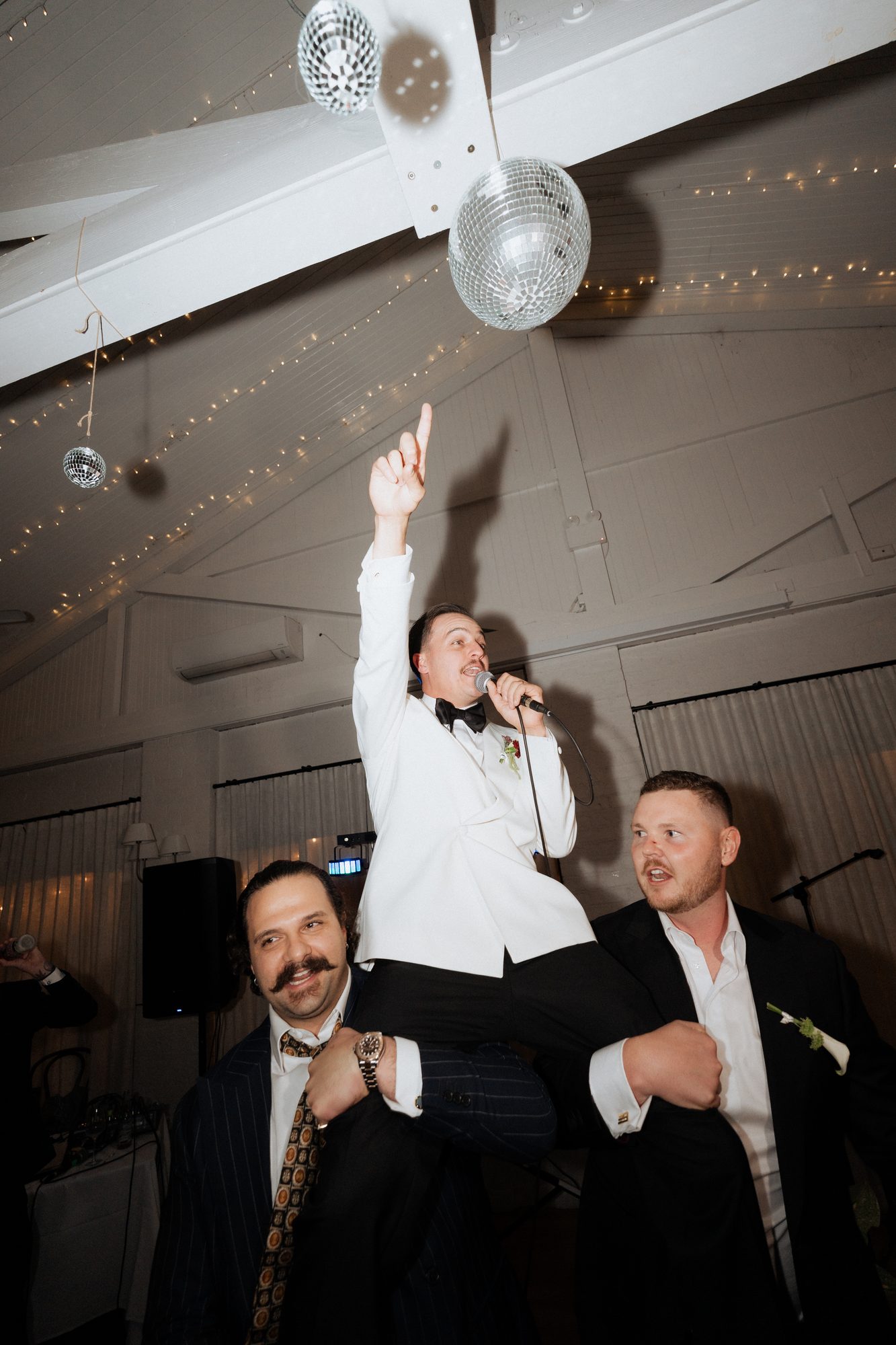 Bill singing on his groomsmen's shoulders under the disco ball — The Lodge Jemberoo wedding